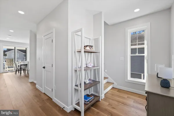 a view of a room with wooden floor and windows