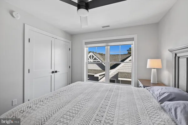 a bedroom with a bed and a large mirror