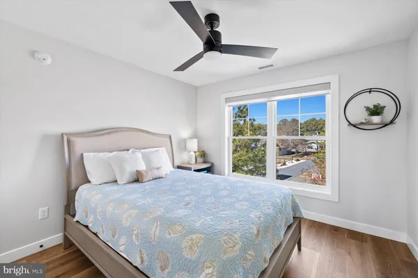 a bed sitting in a bedroom next to a window