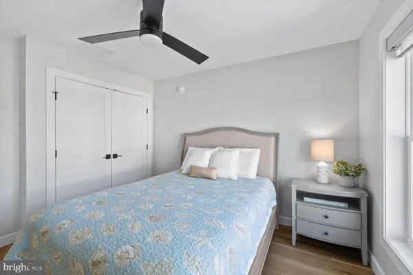 a bedroom with a bed and a potted plant