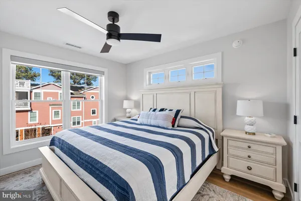 a bedroom with a bed and a large window