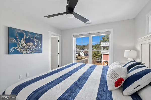 a bedroom with a large bed and a painting on the wall