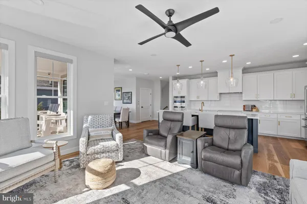 a living room with furniture and kitchen view