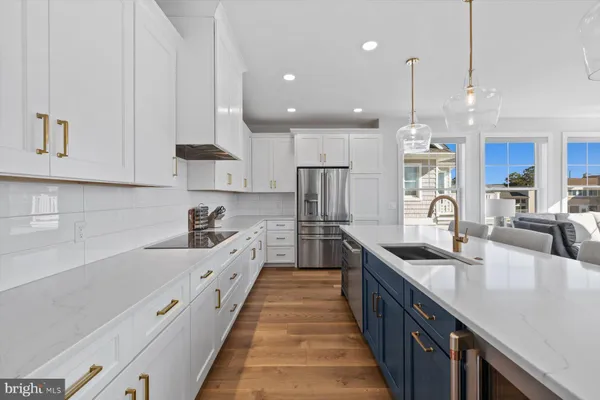 a large kitchen with stainless steel appliances lots of counter space and a sink