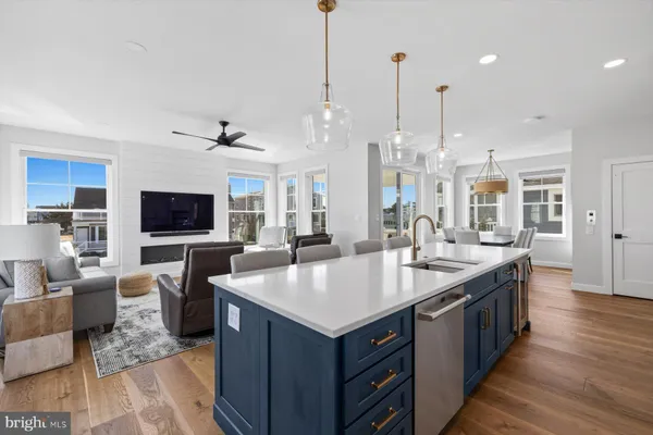 a large kitchen with kitchen island a sink and a living room view