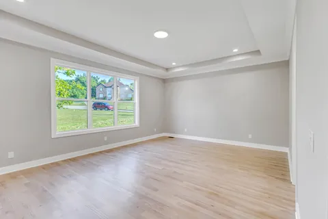 a view of an empty room with a kitchen