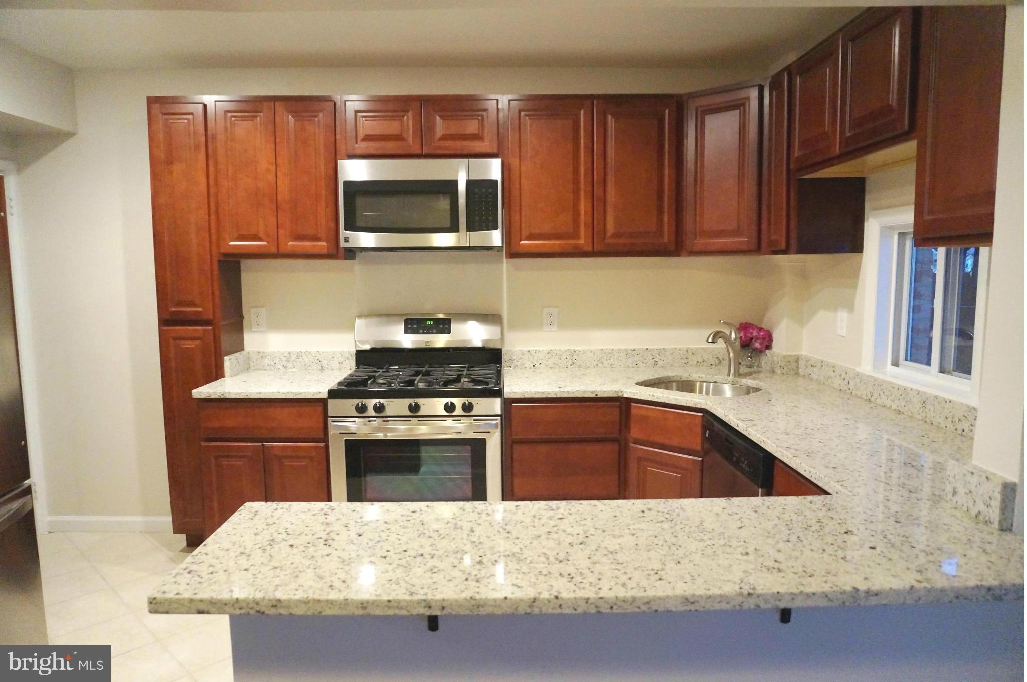 2011 Ormand Road Baltimore, MD 21222 - Photo 1 of 28 a kitchen with granite countertop a sink stainless steel appliances and cabinets