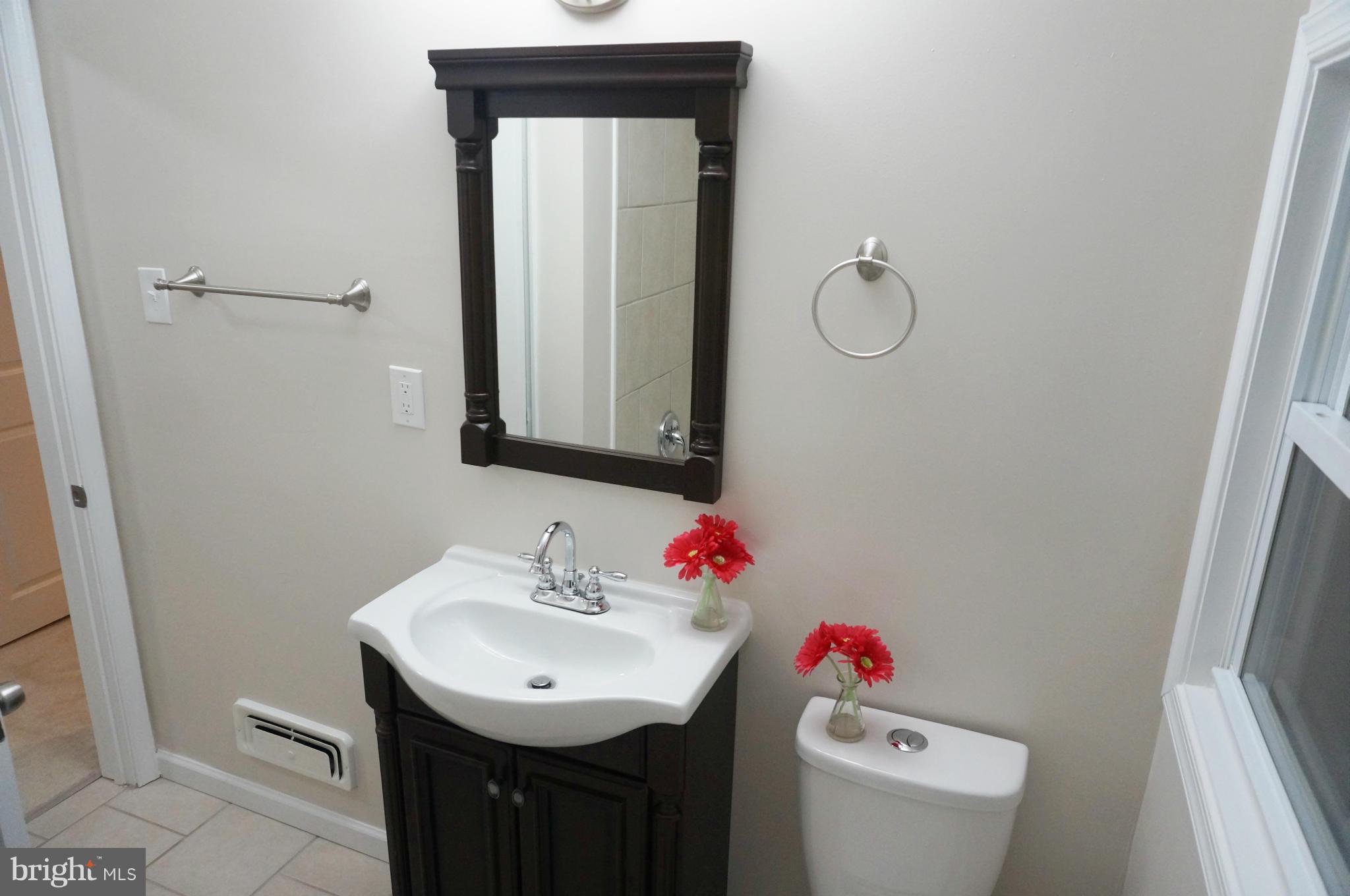 2011 Ormand Road Baltimore, MD 21222 - Photo 12 of 28 a bathroom with a sink toilet and a mirror