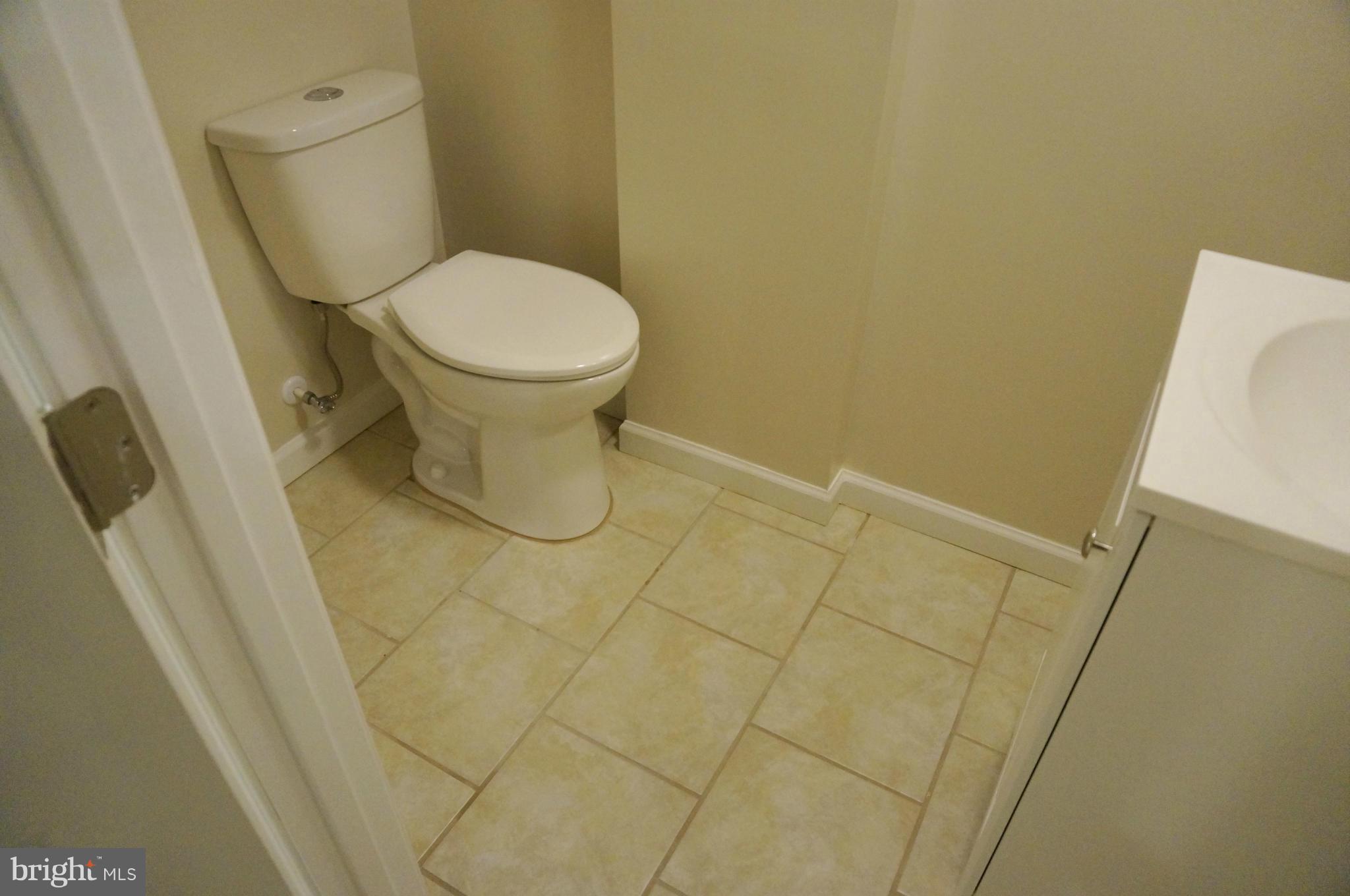 2011 Ormand Road Baltimore, MD 21222 - Photo 20 of 28 a white toilet sitting next to a shower