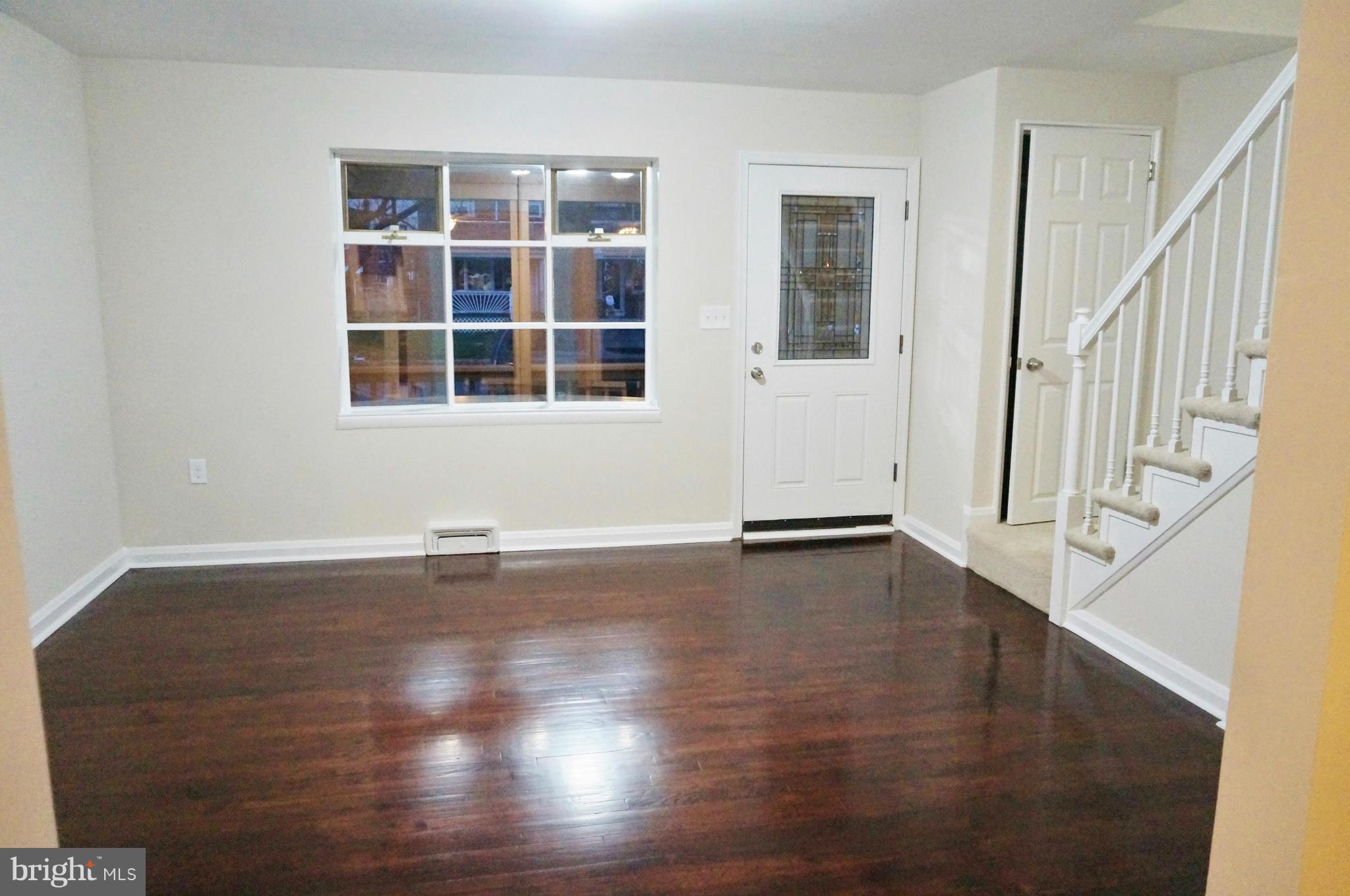 2011 Ormand Road Baltimore, MD 21222 - Photo 3 of 28 a view of an empty room with wooden floor and a window