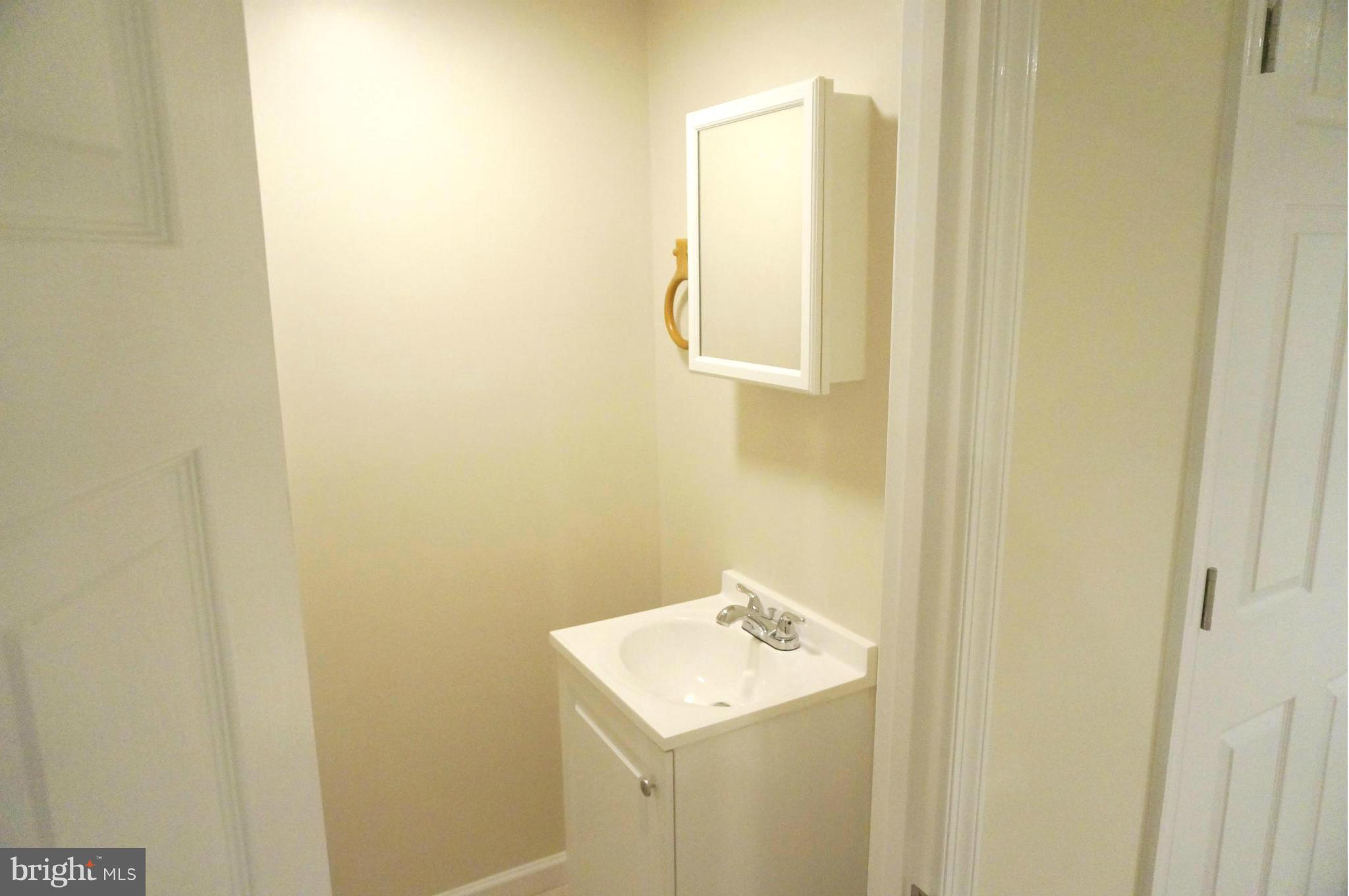 2011 Ormand Road Baltimore, MD 21222 - Photo 21 of 28 a bathroom with a sink and mirror