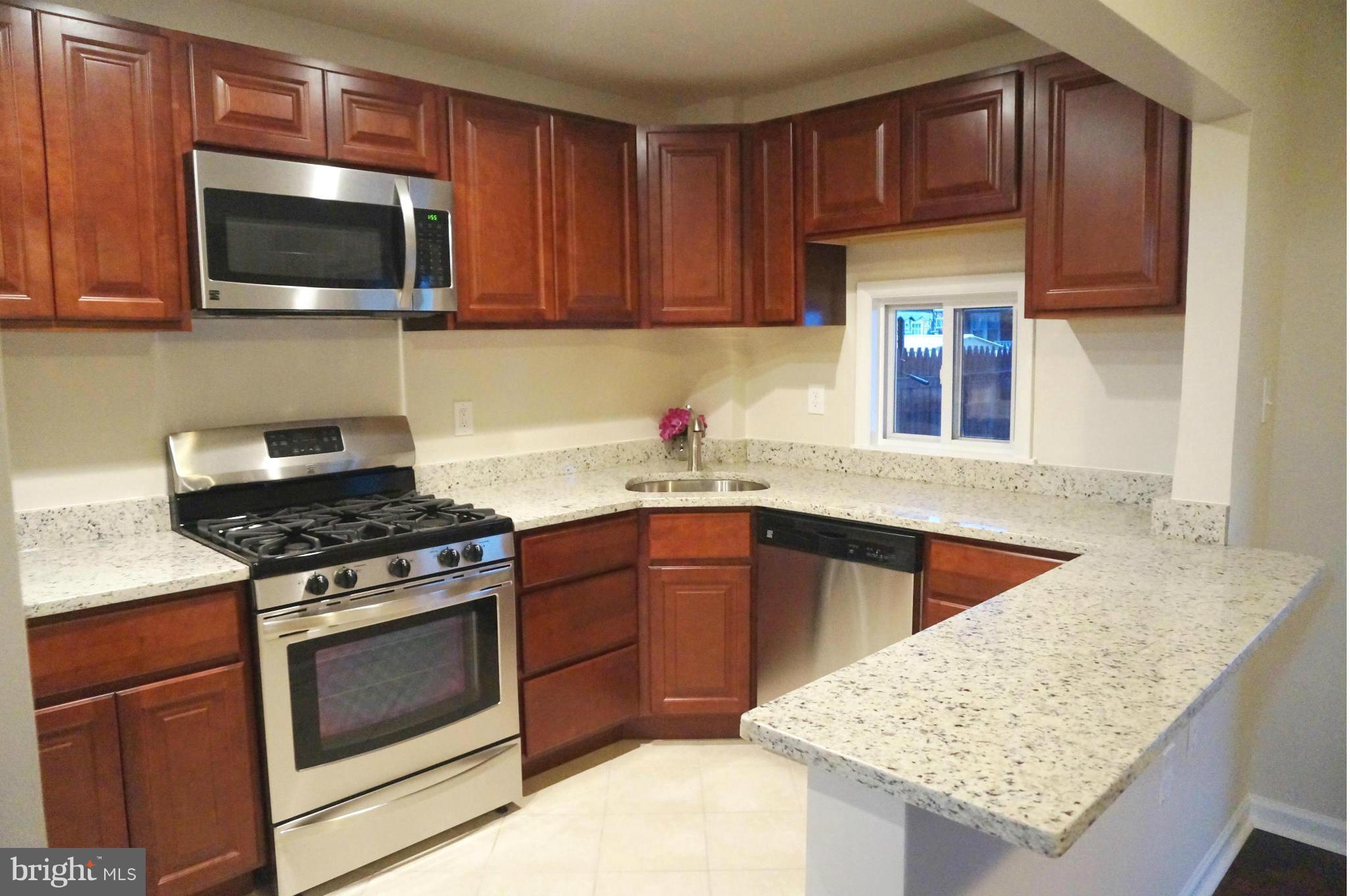 2011 Ormand Road Baltimore, MD 21222 - Photo 4 of 28 a kitchen with stainless steel appliances granite countertop a stove microwave and sink
