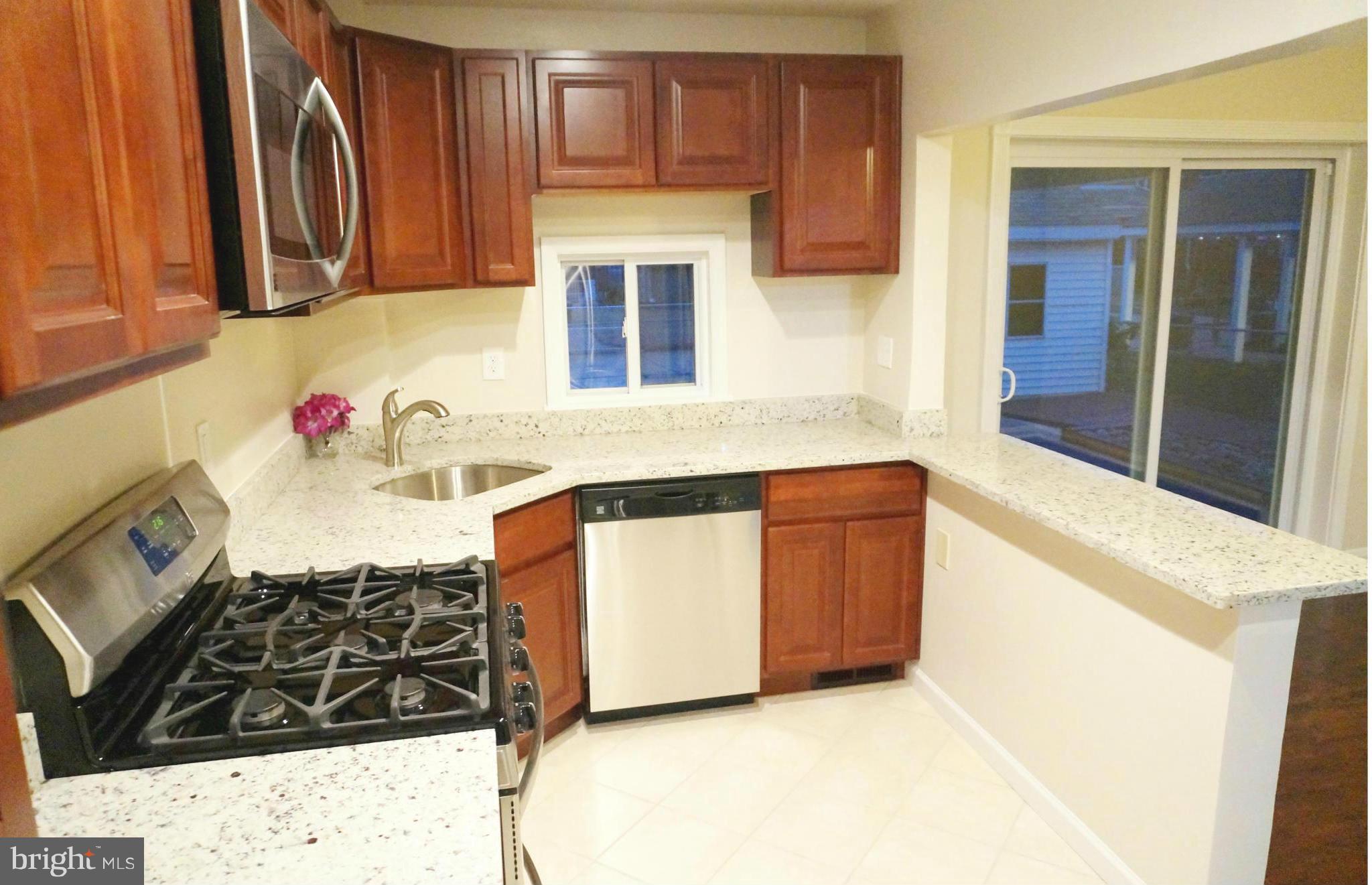 2011 Ormand Road Baltimore, MD 21222 - Photo 6 of 28 a kitchen with stainless steel appliances granite countertop a stove and a sink