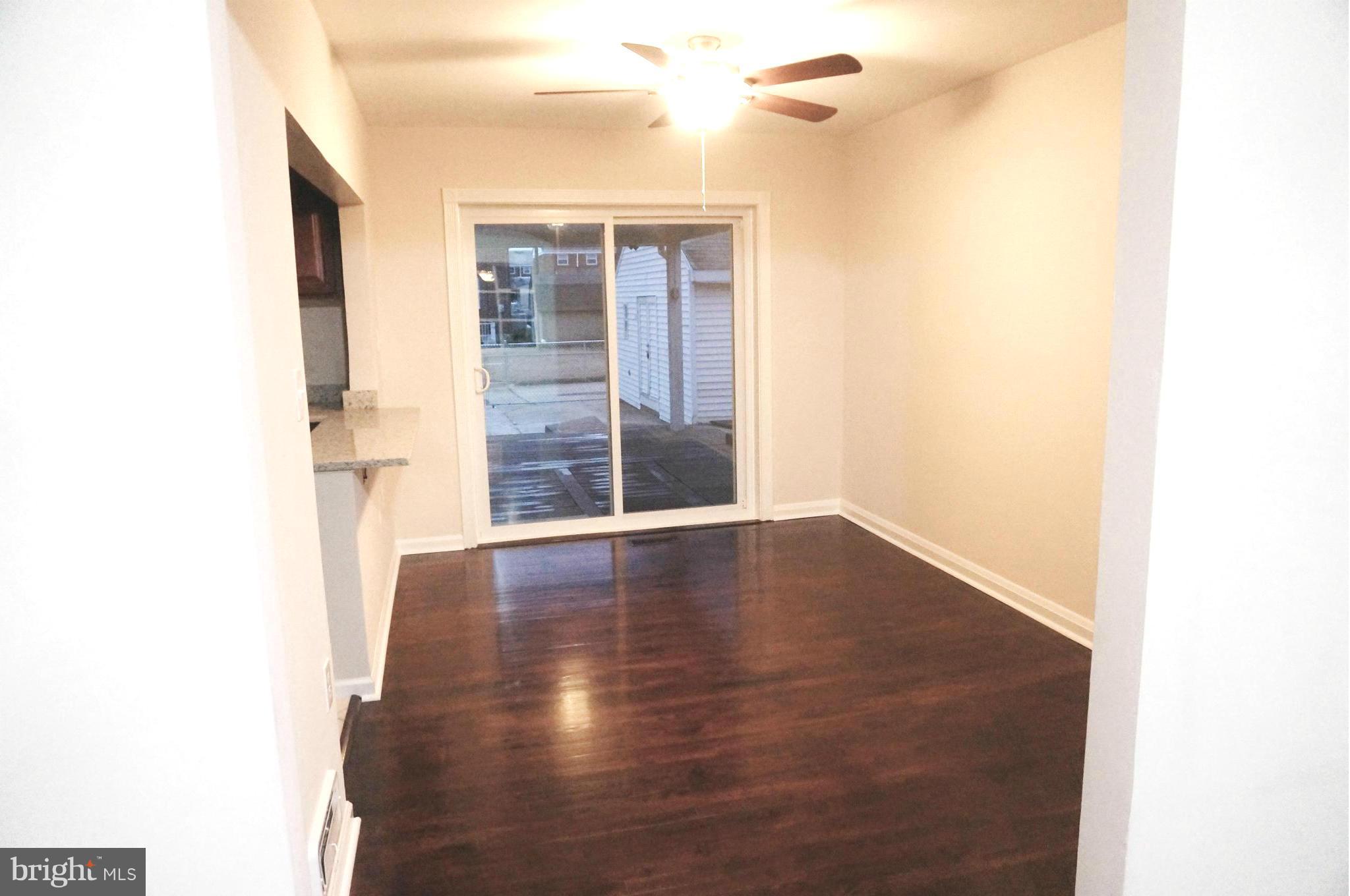 2011 Ormand Road Baltimore, MD 21222 - Photo 8 of 28 a view of an empty room with wooden floor and a window
