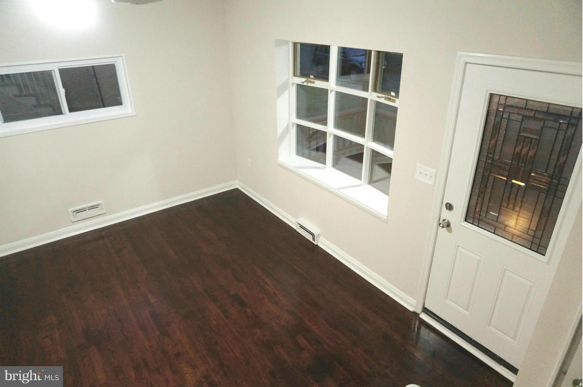 2011 Ormand Road Baltimore, MD 21222 - Photo 9 of 28 a view of an empty room with wooden floor and a window