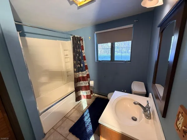 a bathroom with a sink toilet and tub