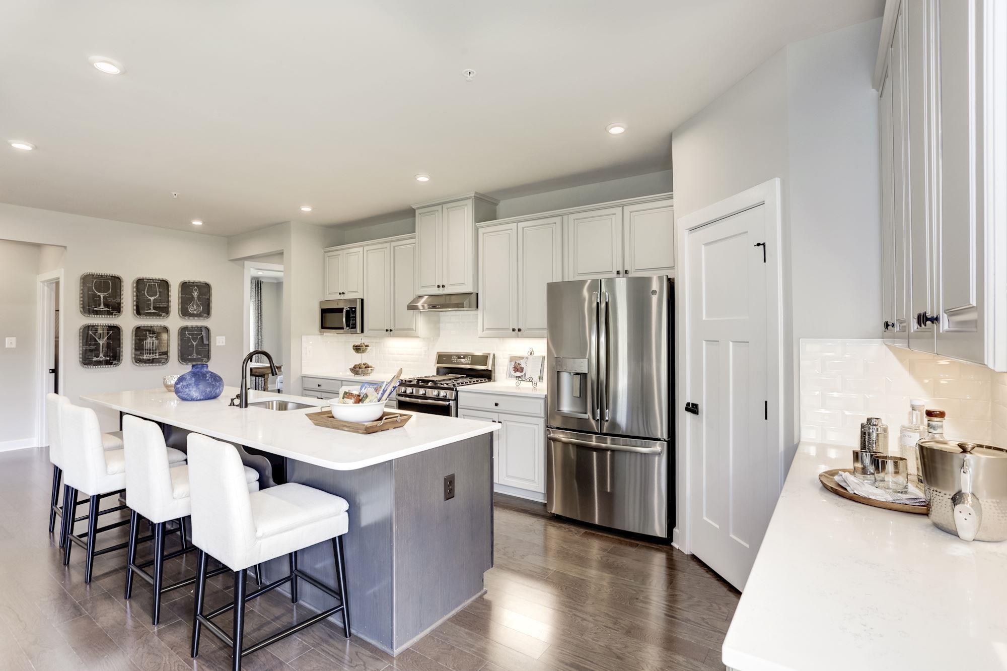 2100 Hope Pointe Drive North Myrtle Beach, SC 29582 - Photo 3 of 12 Kitchen with appliances with stainless steel finishes, recessed lighting, a kitchen island with sink, a breakfast bar area, and dark wood-style floors