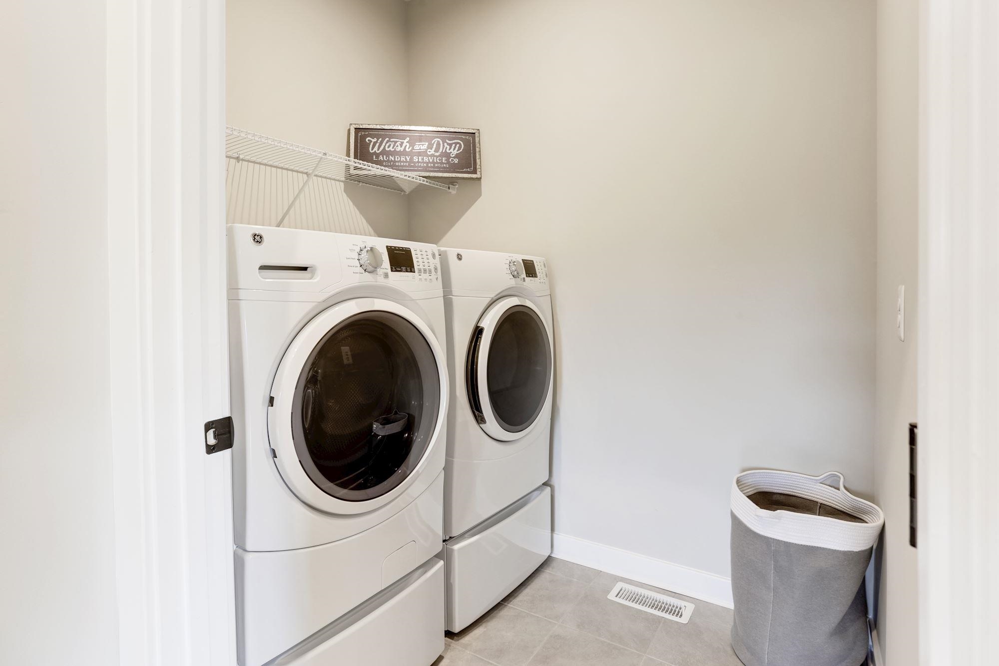 2100 Hope Pointe Drive North Myrtle Beach, SC 29582 - Photo 10 of 12 Washroom with light tile patterned floors and washing machine and clothes dryer