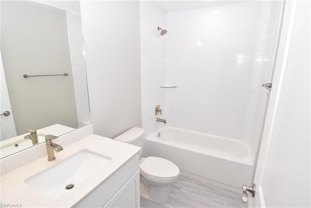 2121 Firebrand Road North Port, FL 34288 - Photo 16 of 22 Full bathroom featuring vanity, bathtub / shower combination, and light wood-type flooring