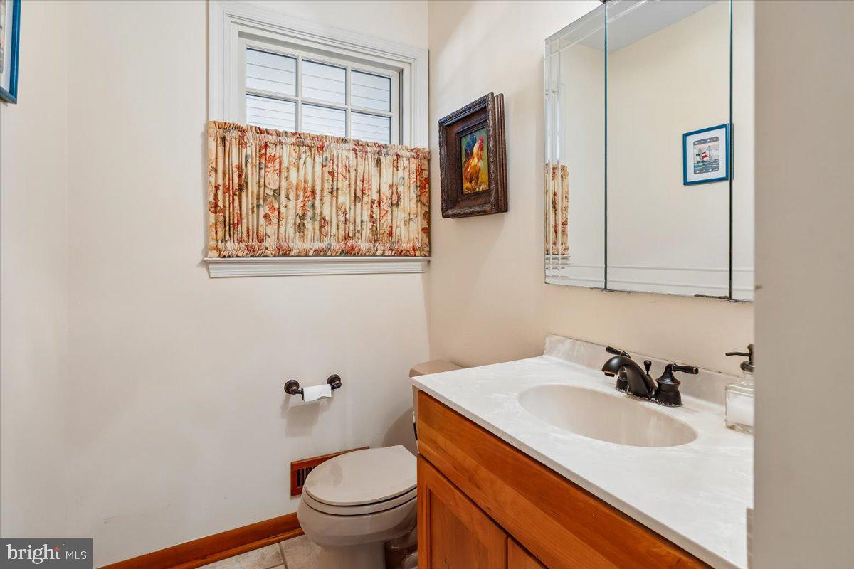 7918 Ruxway Road Towson, MD 21204 - Photo 18 of 36 a bathroom with a sink toilet and mirror