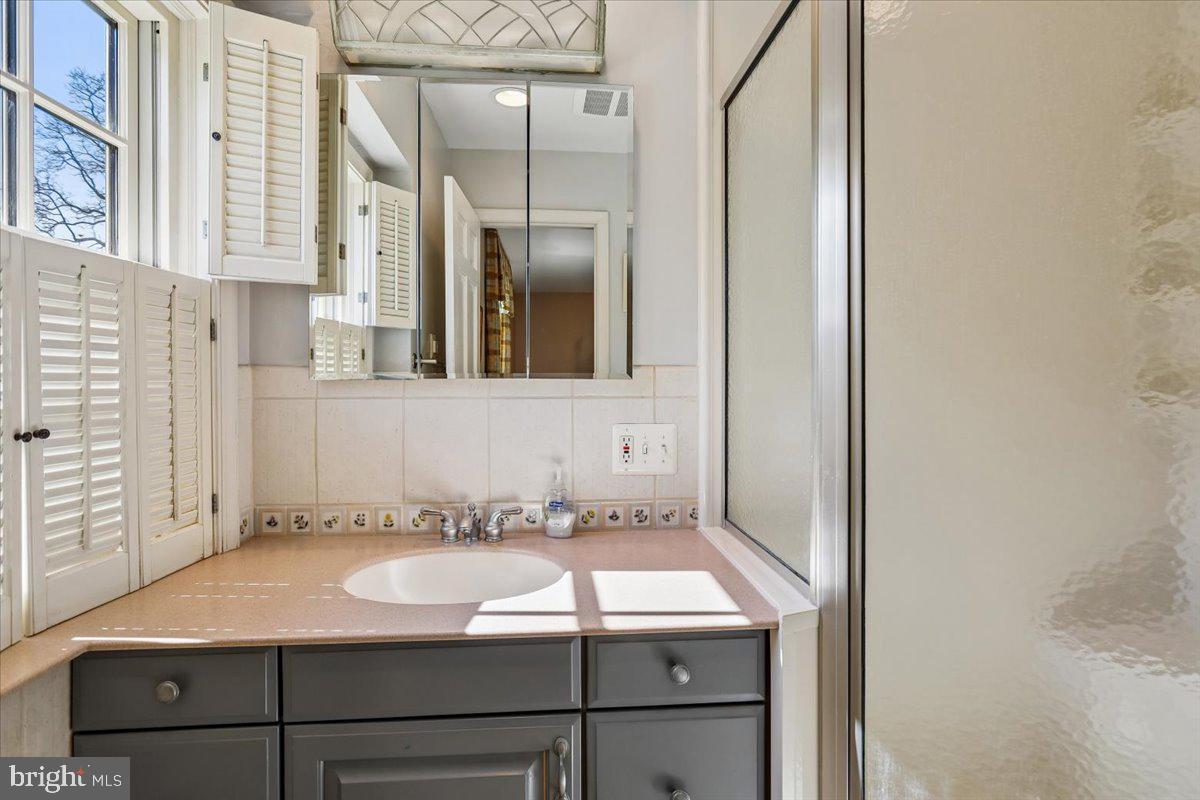 7918 Ruxway Road Towson, MD 21204 - Photo 21 of 36 a bathroom with a sink and a mirror