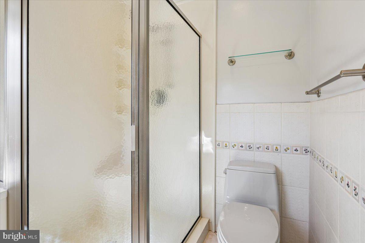 7918 Ruxway Road Towson, MD 21204 - Photo 22 of 36 a bathroom with a toilet and a shower