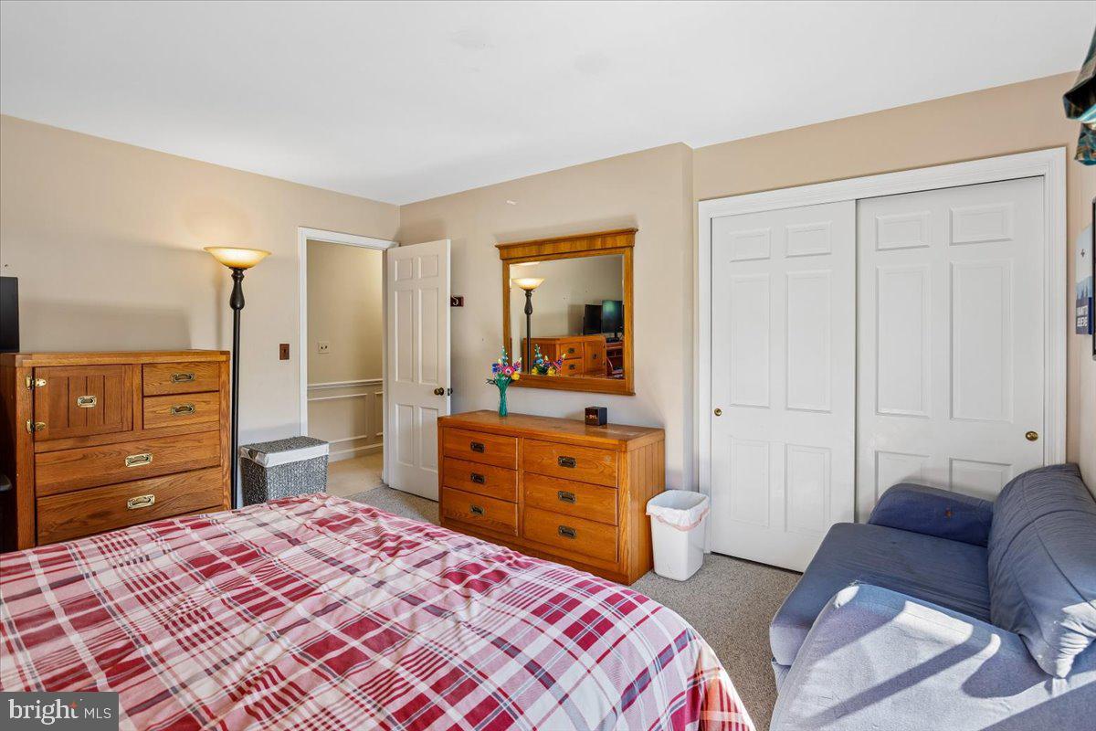 7918 Ruxway Road Towson, MD 21204 - Photo 26 of 36 a bedroom with a bed and a dresser in it