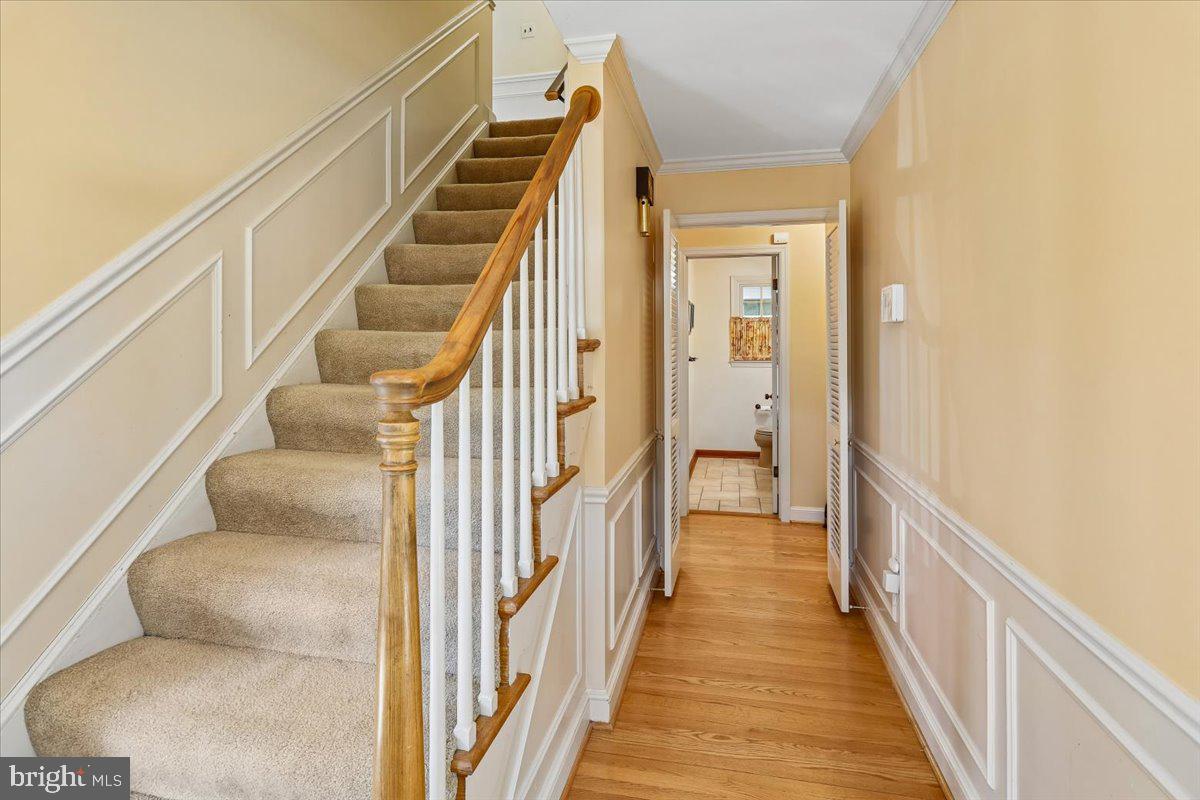 7918 Ruxway Road Towson, MD 21204 - Photo 6 of 36 a view of a hallway with wooden floor and staircase