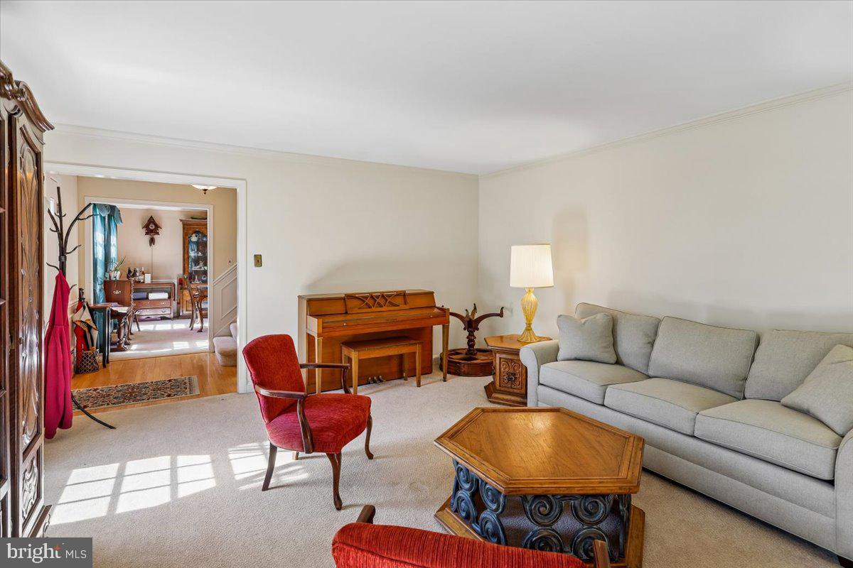 7918 Ruxway Road Towson, MD 21204 - Photo 10 of 36 a living room with furniture a dining table and a chandelier