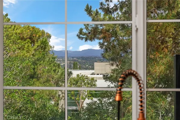a view of a house with a tree in the background