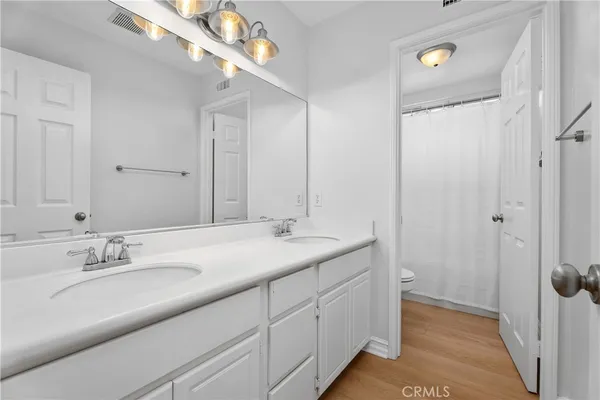 a bathroom with a double vanity sink and mirror