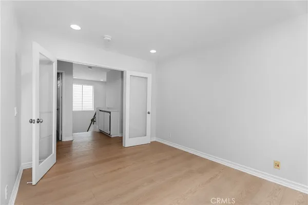 a view of a room with wooden floor and window