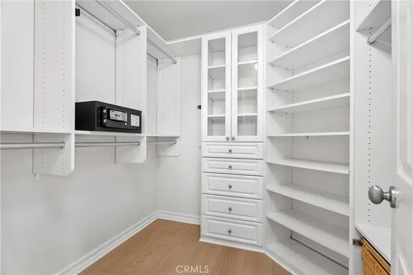a view of walk in closet with empty racks