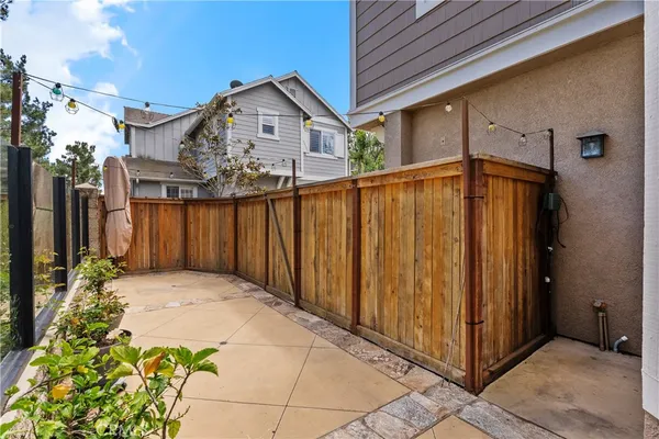 a view of a house with a wooden fence