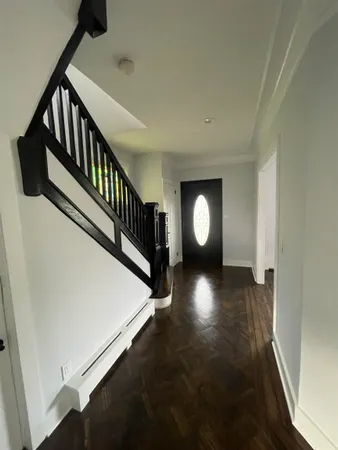 a view of entryway and hall with wooden floor