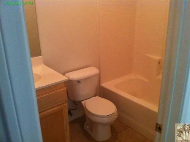 a white toilet sitting next to a bath tub
