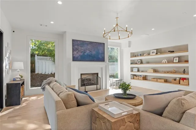 an open kitchen with granite countertop a stove a sink a dining table and chairs
