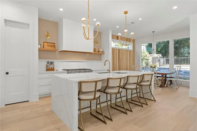 a kitchen with stainless steel appliances granite countertop a stove a sink and a microwave