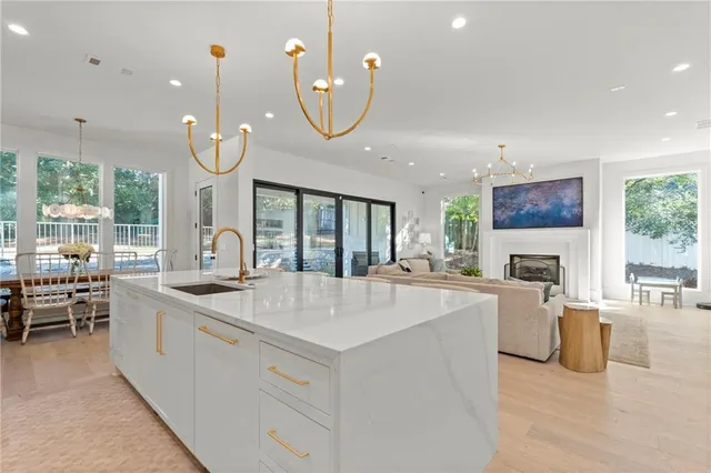 a bedroom with a large bed and a chandelier