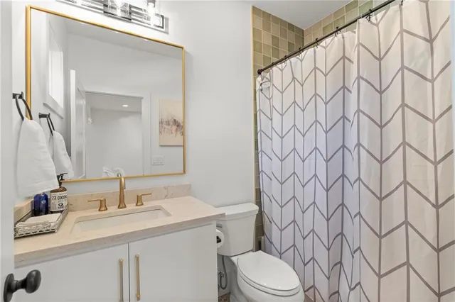 a bedroom with a double vanity sink and a mirror