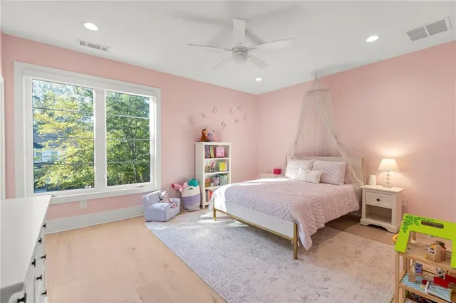 a bedroom with furniture and a flat screen tv