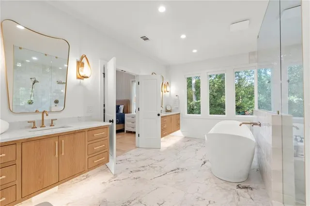 a living room with patio furniture and a floor to ceiling window