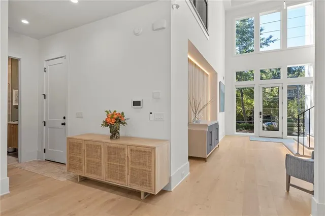 a living room with furniture a fireplace and a floor to ceiling window