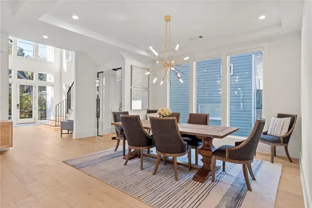 a living room with furniture a fireplace and a chandelier