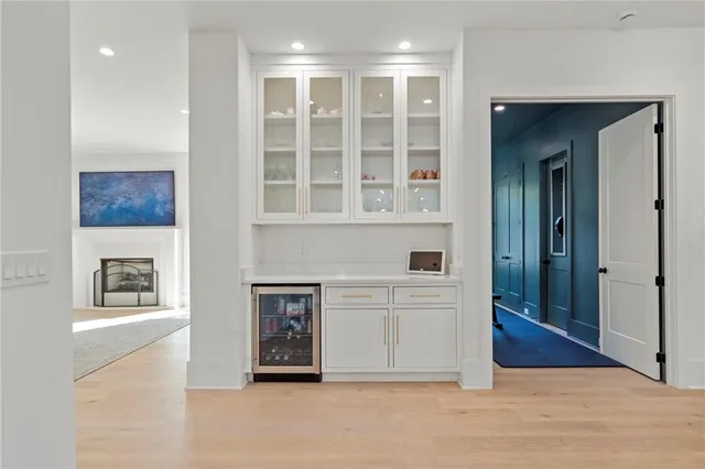 a living room with furniture kitchen and a chandelier