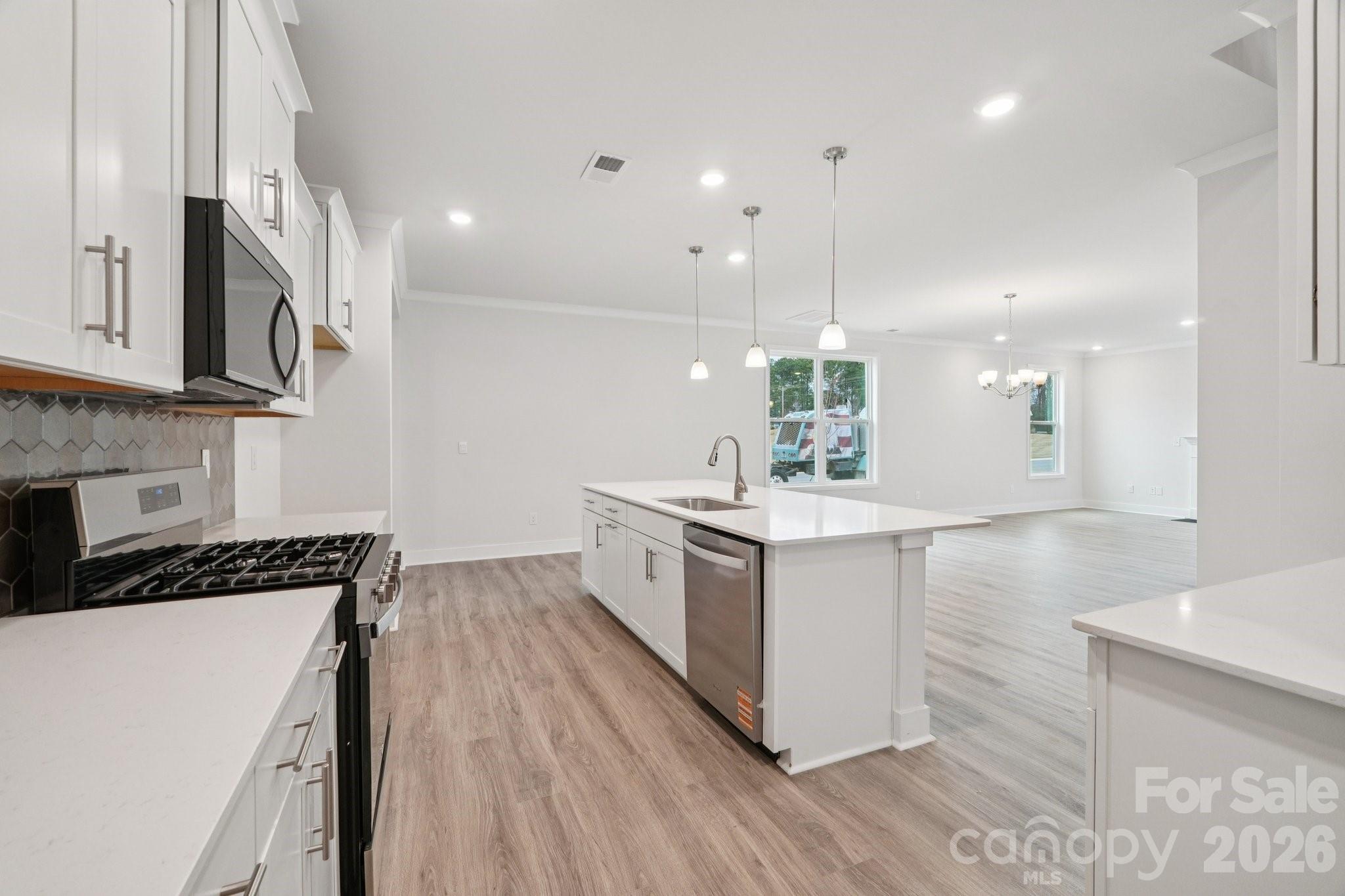 7685 Bainbridge Road Sherrills Ford, NC 28673 - Photo 14 of 33 a kitchen with stainless steel appliances sink stove and cabinets
