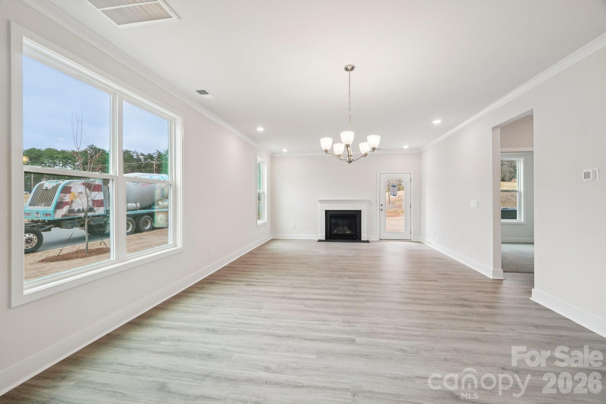 7685 Bainbridge Road Sherrills Ford, NC 28673 - Photo 4 of 33 a view of an empty room with wooden floor and a window