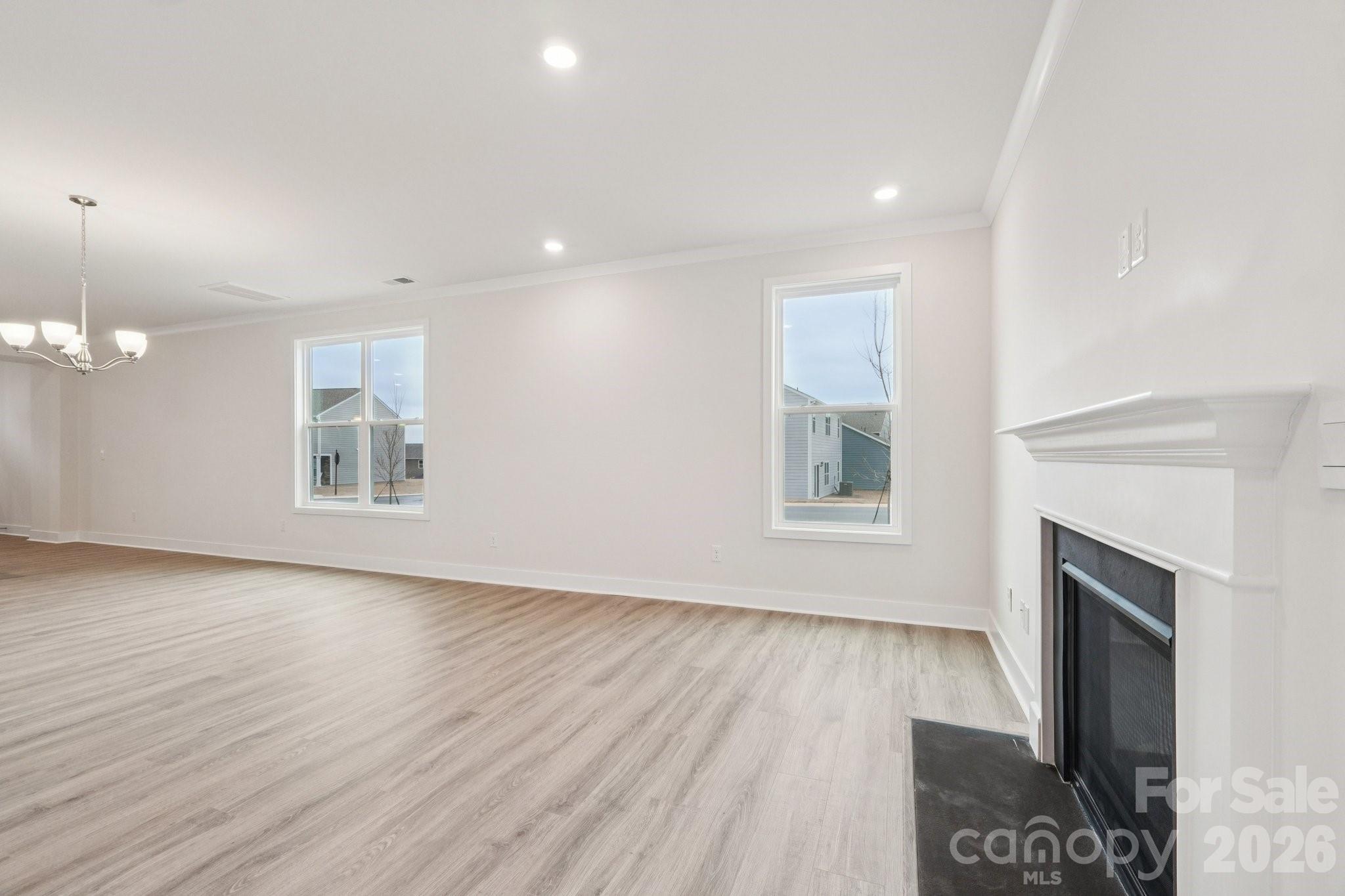 7685 Bainbridge Road Sherrills Ford, NC 28673 - Photo 7 of 33 a view of an empty room with a fireplace and wooden floor