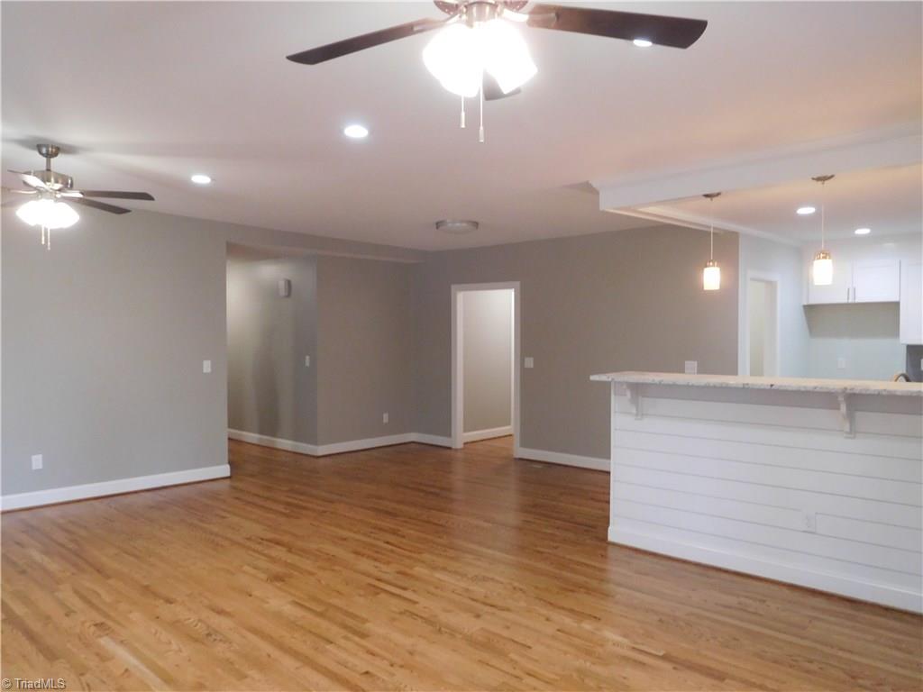 Open floor concept. Living room looking into Kitchen & Dining room.  Beautiful gray color scheme throughout home.