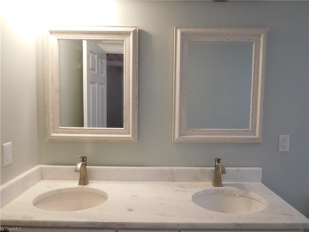 261 Jones Road Winston-Salem, NC 27107 - Photo 14 of 28 Hall Bathroom has double sink granite top vanity & Tiled floor.